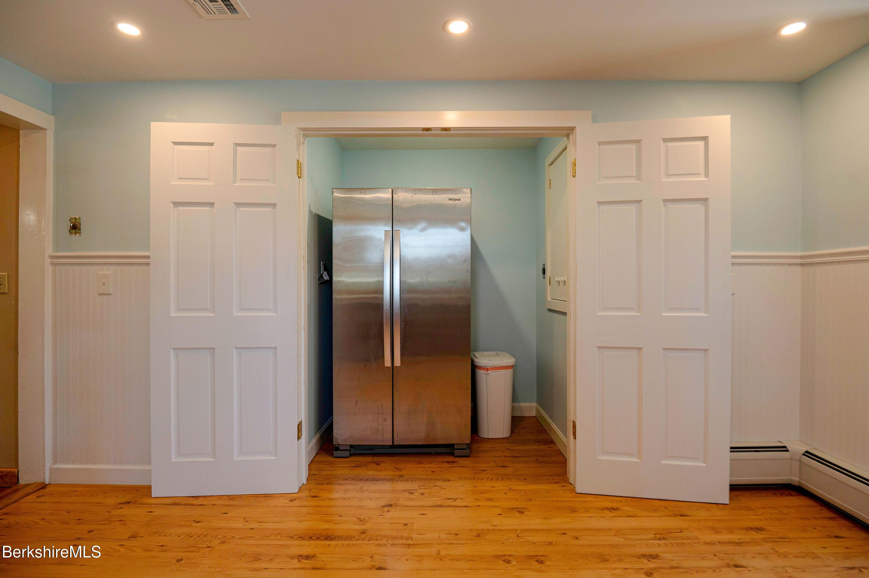 28 Adell Street Pittsfield, MA 01201 - Photo 11 of 26 a view of a refrigerator in kitchen and an empty room