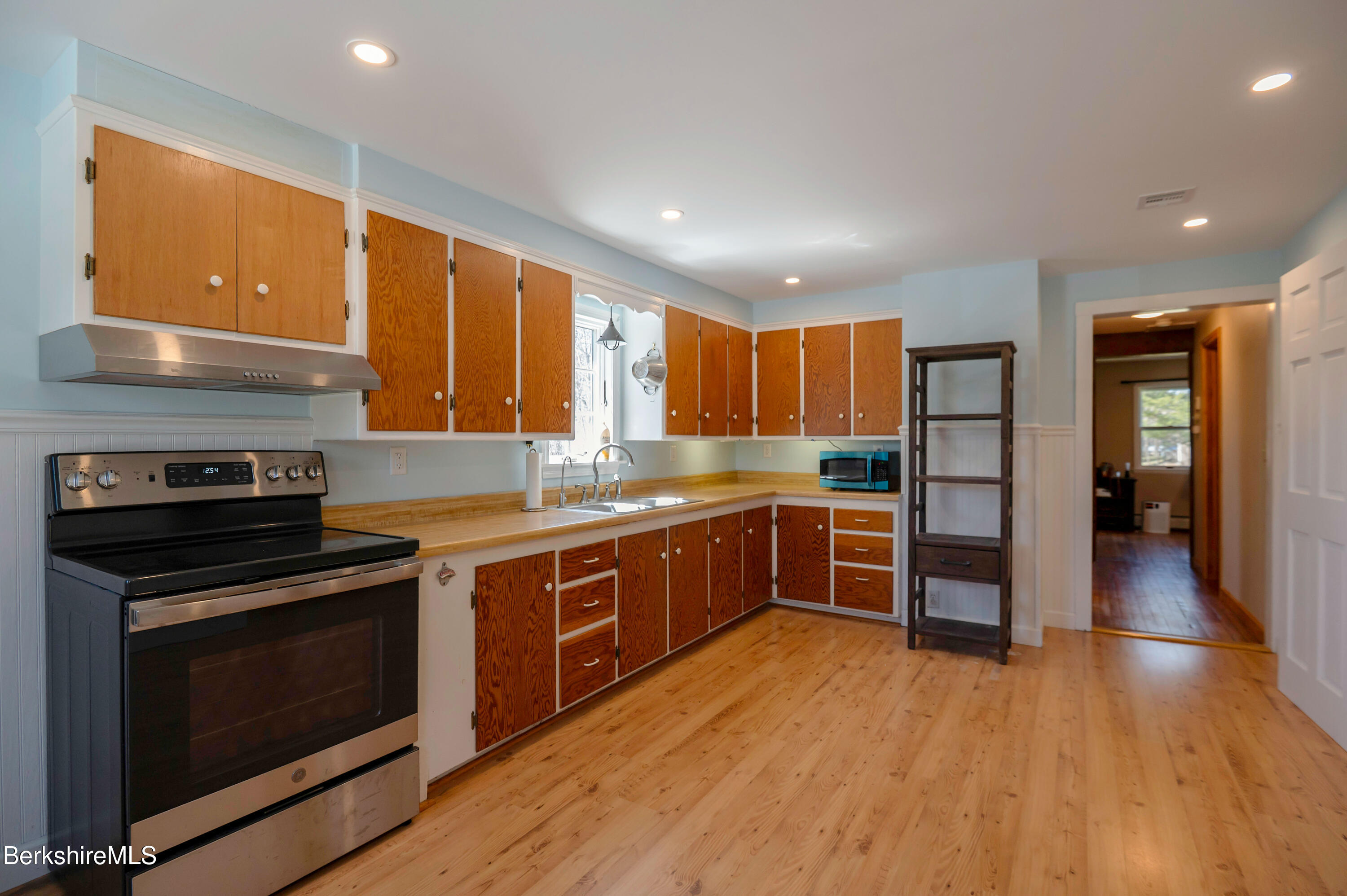 28 Adell Street Pittsfield, MA 01201 - Photo 13 of 26 a large kitchen with stainless steel appliances granite countertop a stove and a sink
