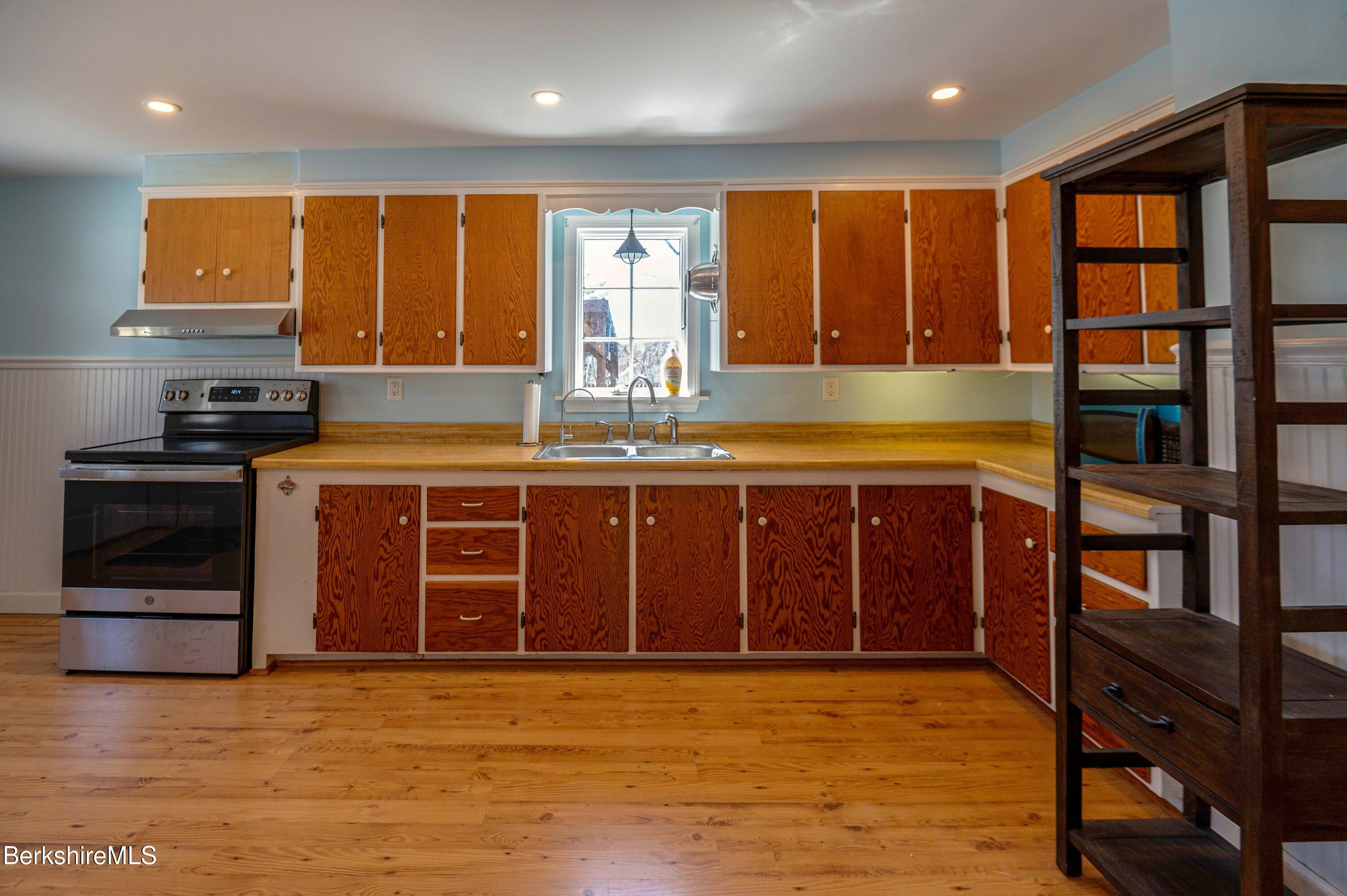 28 Adell Street Pittsfield, MA 01201 - Photo 14 of 26 a kitchen with stainless steel appliances granite countertop a stove and a refrigerator
