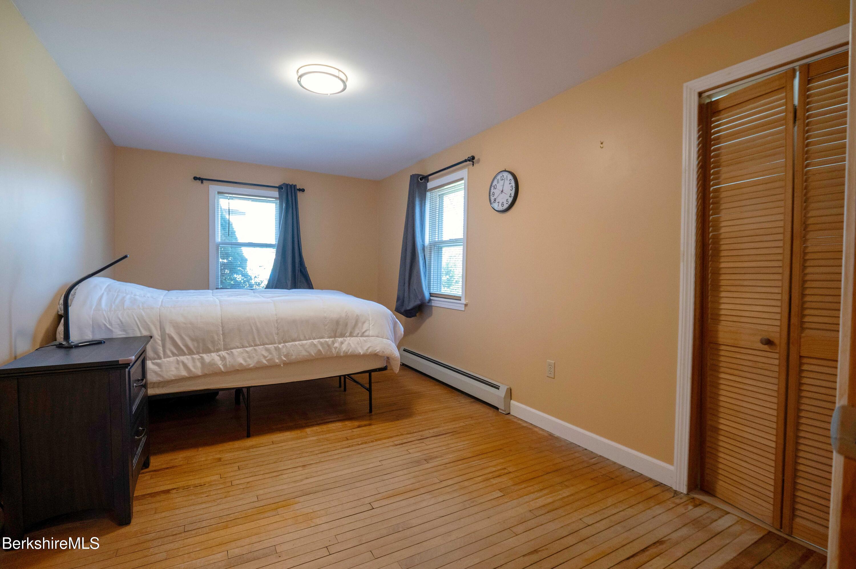 28 Adell Street Pittsfield, MA 01201 - Photo 17 of 26 a bedroom with a bed and wooden floor