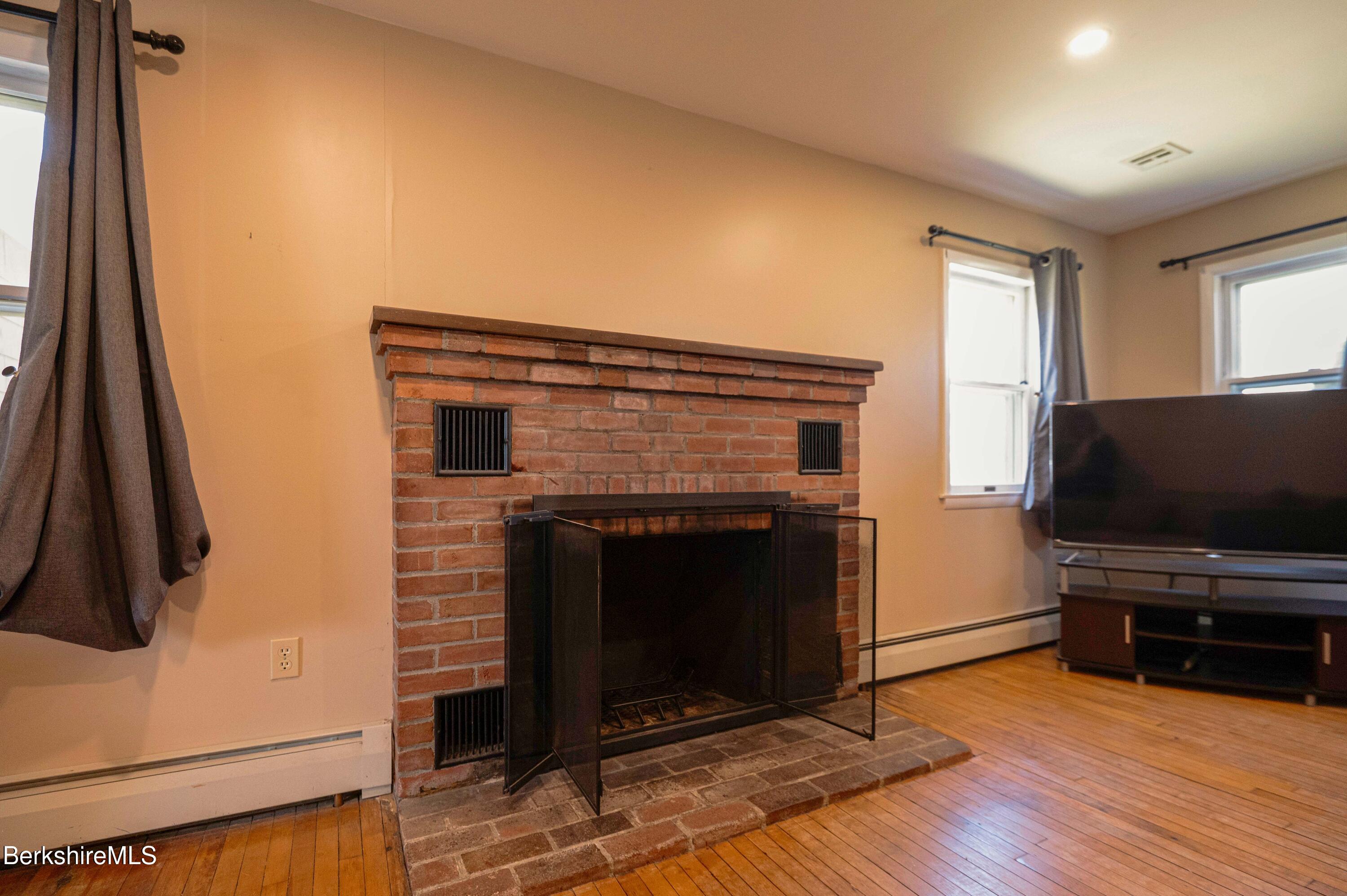 28 Adell Street Pittsfield, MA 01201 - Photo 21 of 26 a living room with furniture and a fireplace
