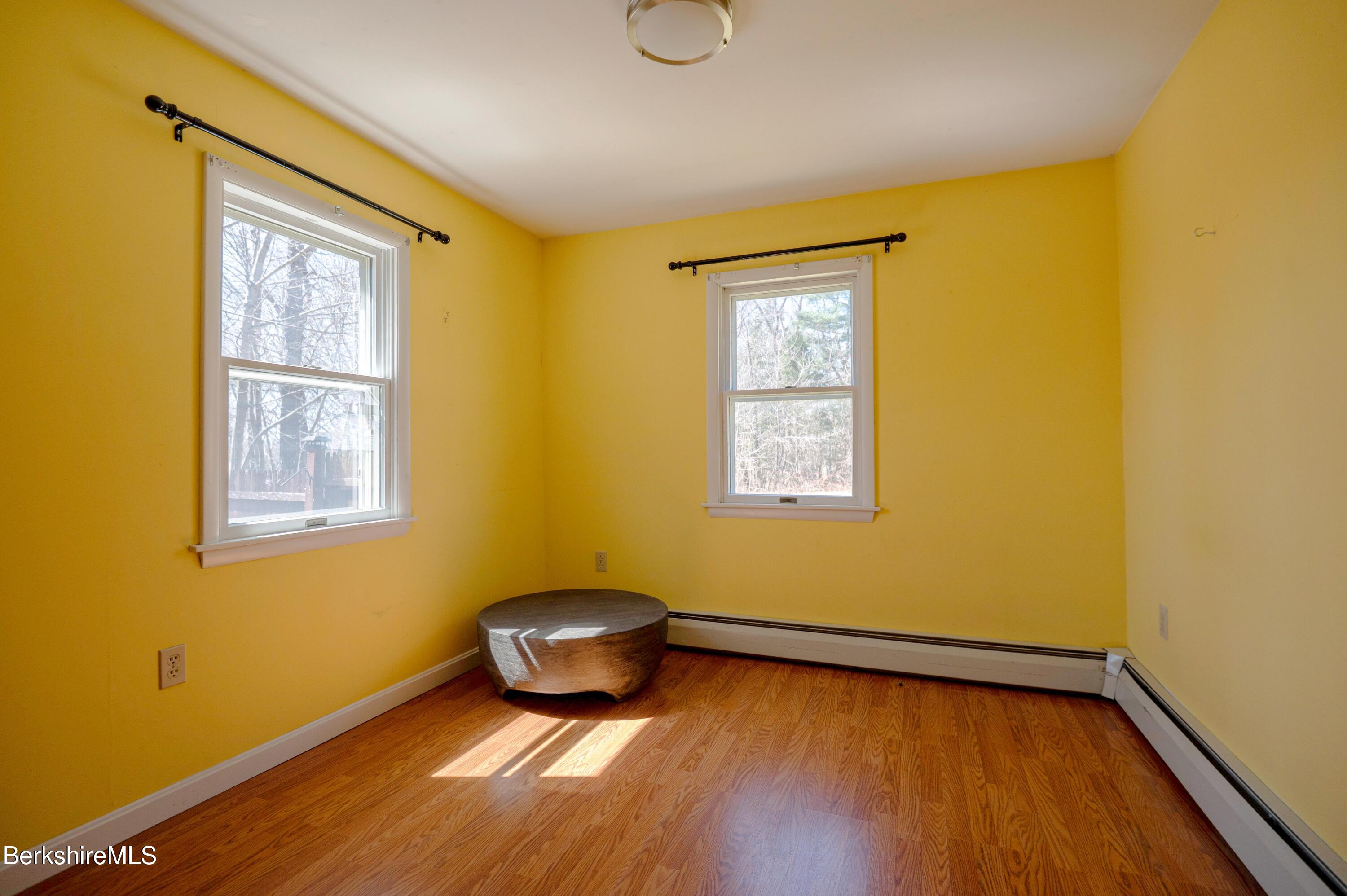28 Adell Street Pittsfield, MA 01201 - Photo 23 of 26 a view of an empty room with wooden floor and a window