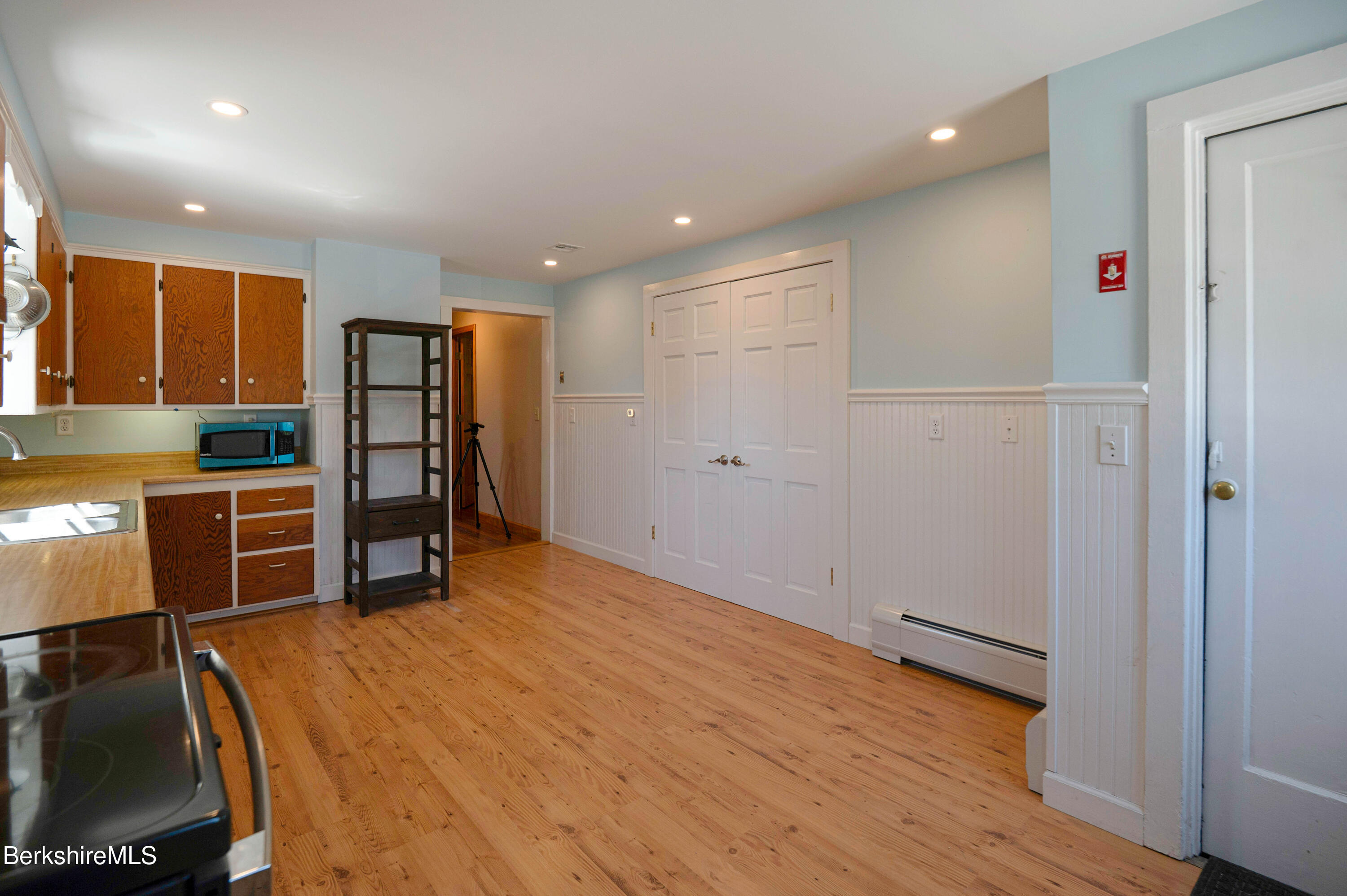 28 Adell Street Pittsfield, MA 01201 - Photo 10 of 26 a view of kitchen with refrigerator and wooden floor