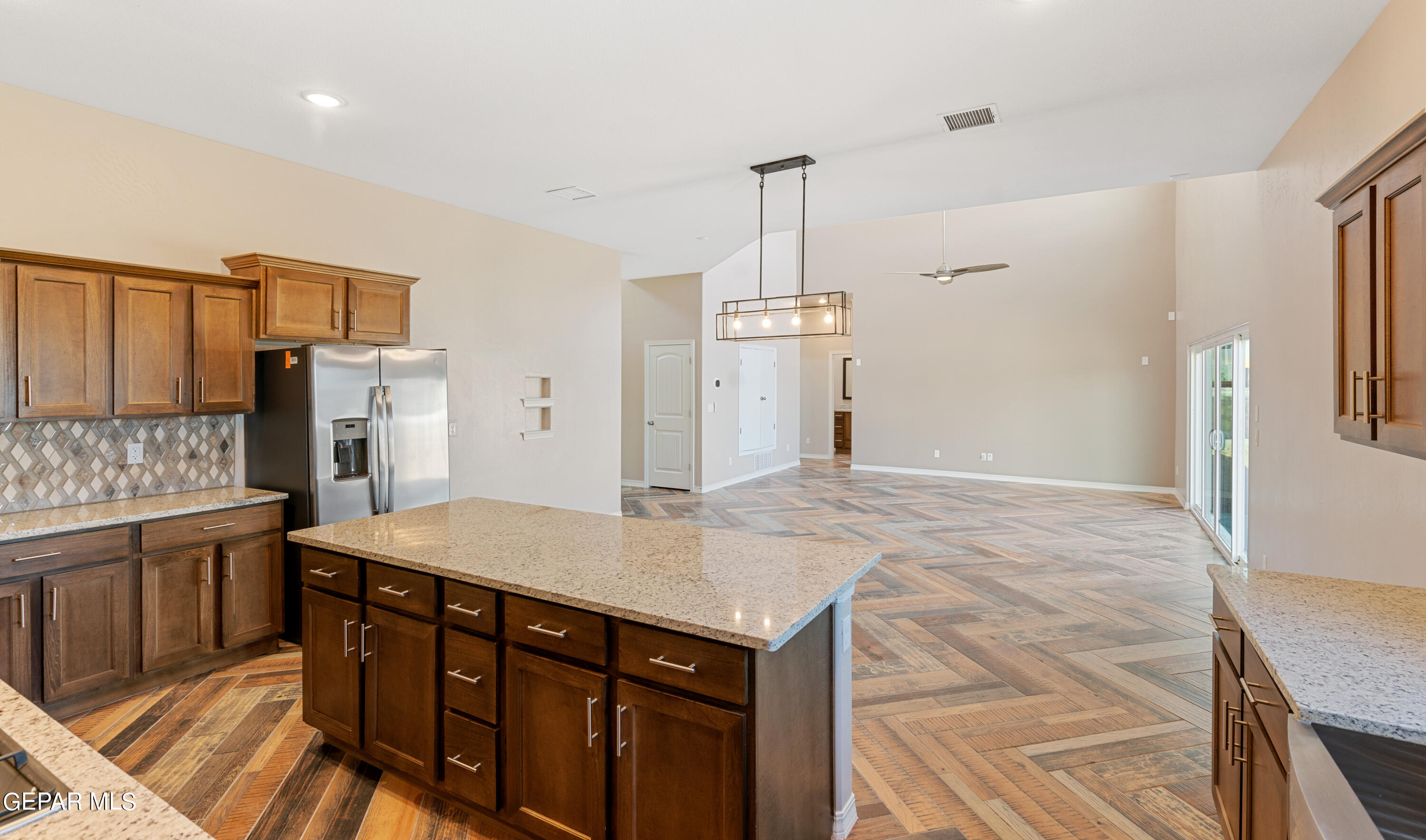415 Masoud Court El Paso, TX 79932 - Photo 11 of 19 a kitchen with stainless steel appliances granite countertop a sink refrigerator and cabinets