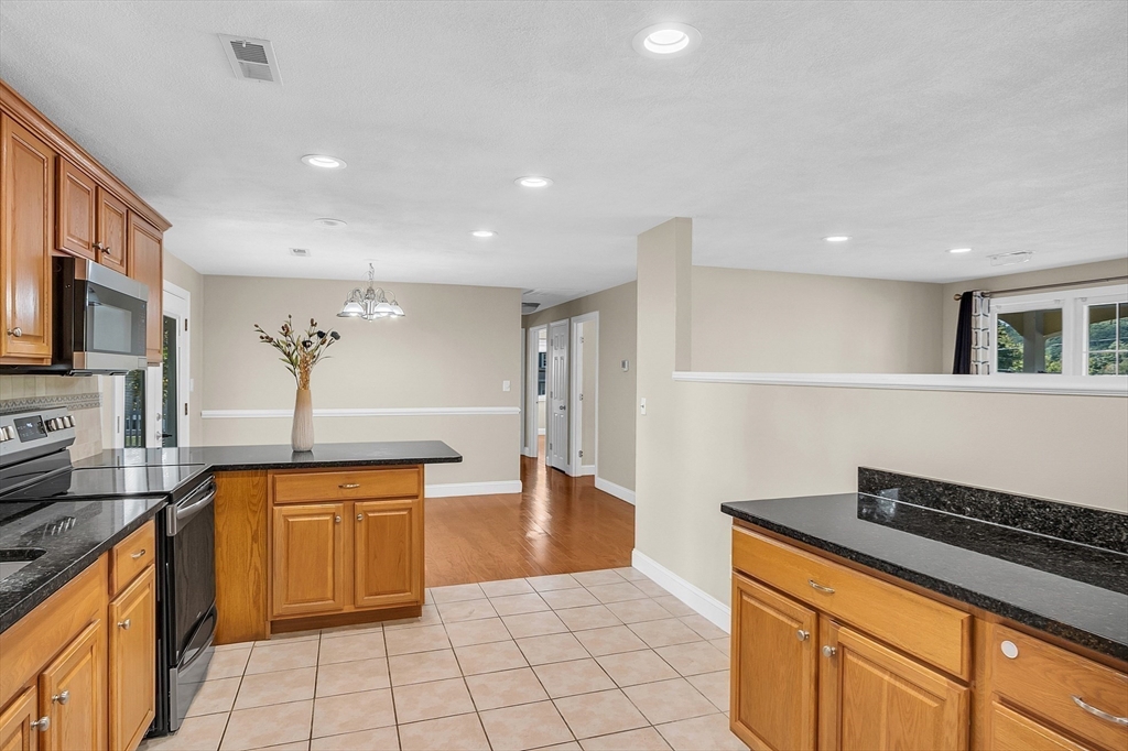 1 Alan Road Hudson, MA 01749 - Photo 16 of 38 a kitchen with stainless steel appliances granite countertop a sink and a stove