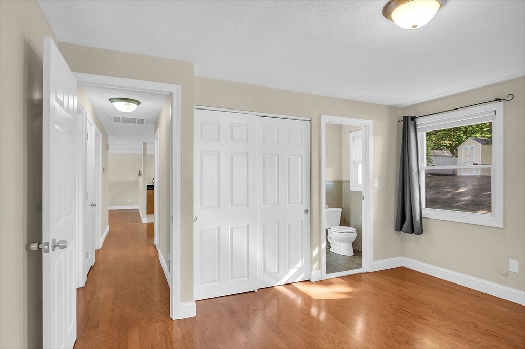 1 Alan Road Hudson, MA 01749 - Photo 23 of 38 a view of an empty room with wooden floor and a window