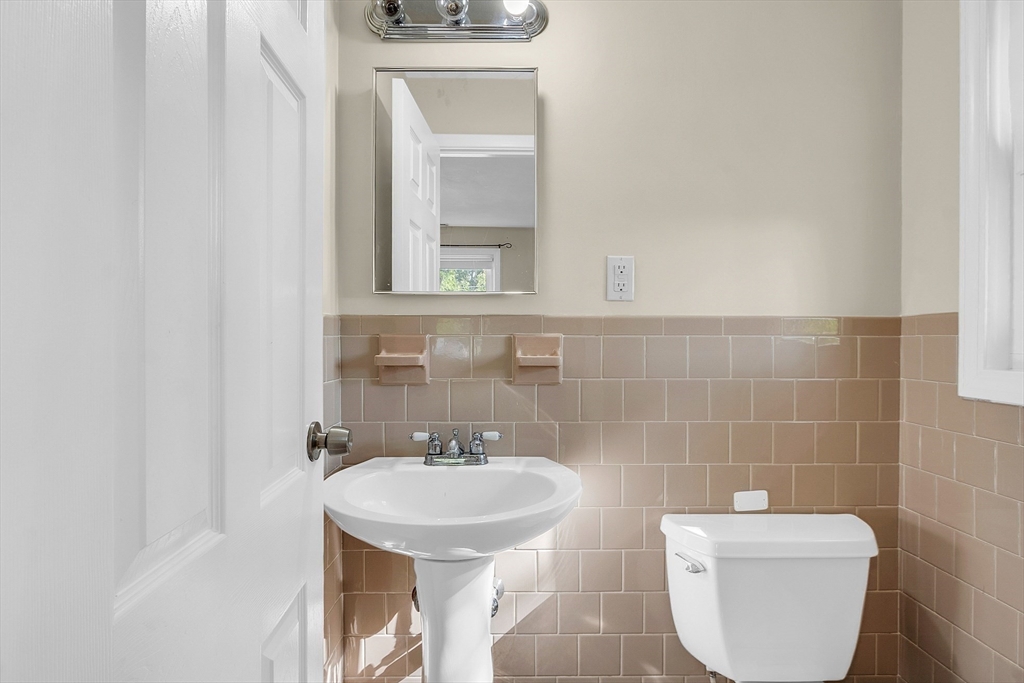 1 Alan Road Hudson, MA 01749 - Photo 25 of 38 a bathroom with a toilet a sink and mirror