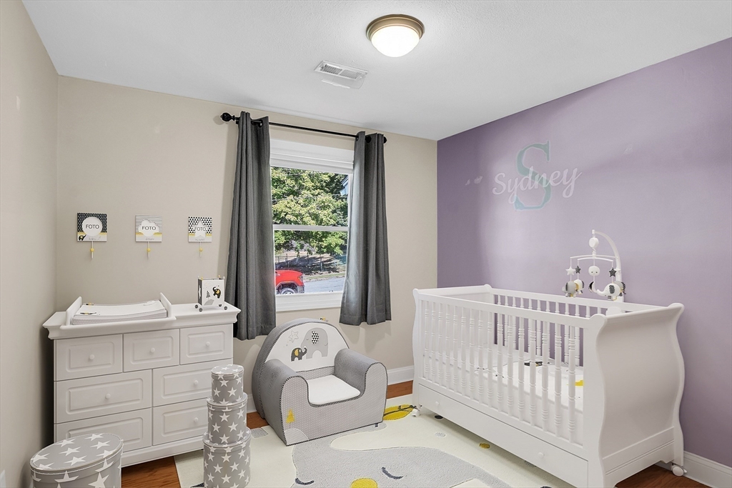 1 Alan Road Hudson, MA 01749 - Photo 27 of 38 a bedroom with a baby bed a couch and dresser