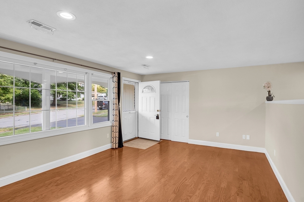 1 Alan Road Hudson, MA 01749 - Photo 5 of 38 an empty room with wooden floor and windows