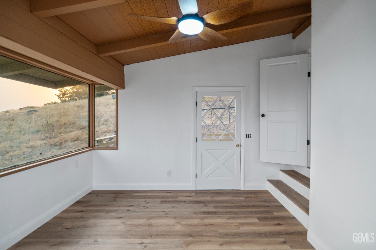 Undisclosed Address Tehachapi, CA 93561 - Photo 32 of 60 a view of an empty room with a window and wooden floor