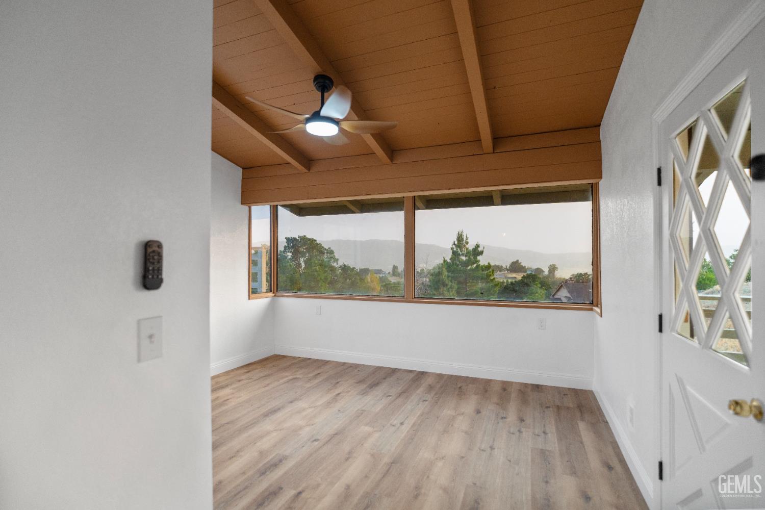 Undisclosed Address Tehachapi, CA 93561 - Photo 35 of 60 an empty room with wooden floor and windows