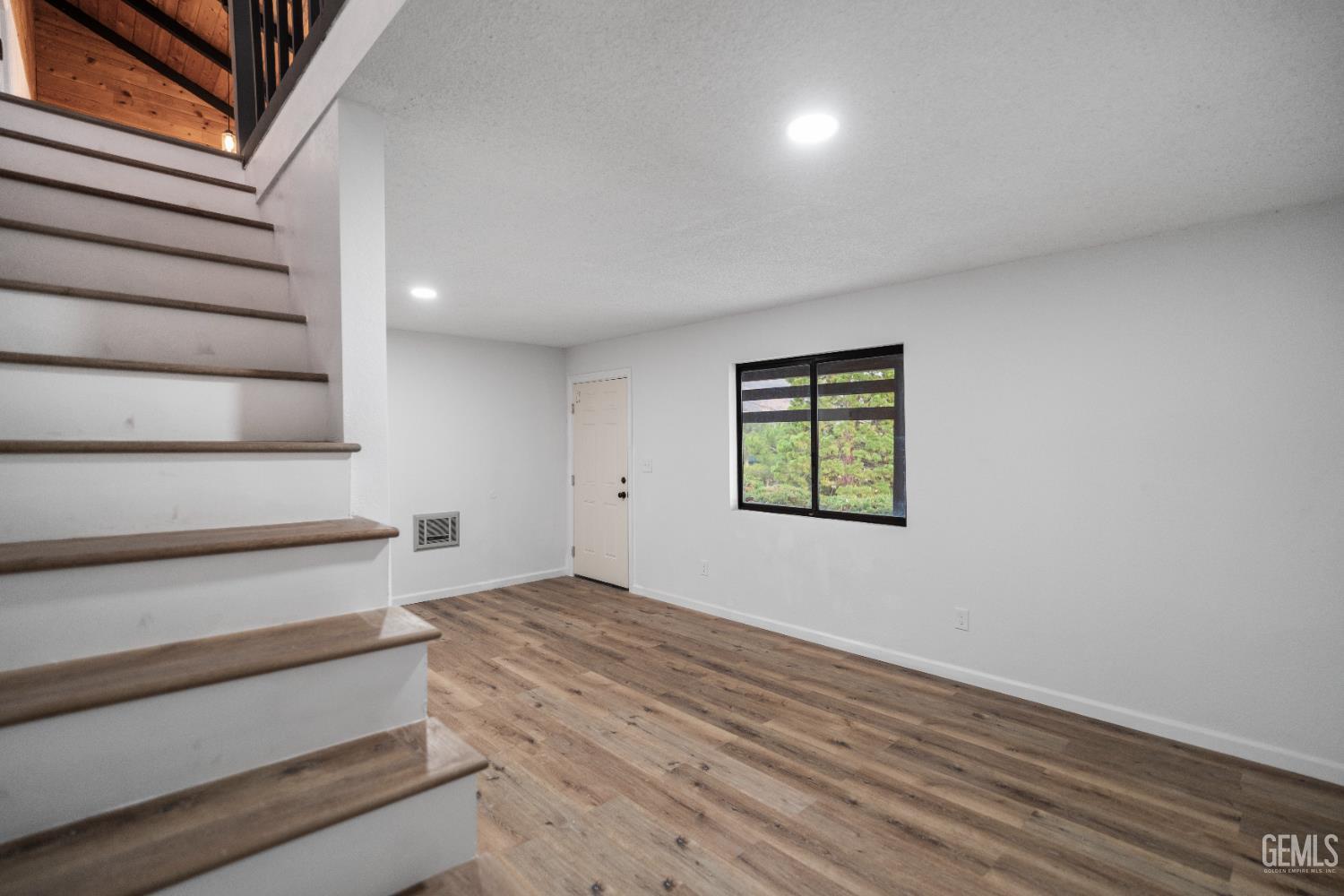 Undisclosed Address Tehachapi, CA 93561 - Photo 37 of 60 a view of wooden floor and windows in a room