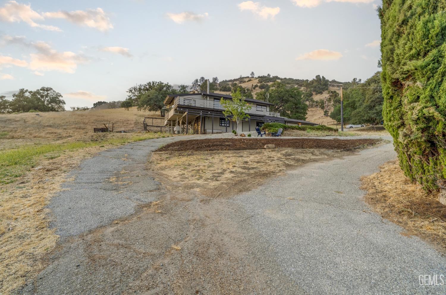 Undisclosed Address Tehachapi, CA 93561 - Photo 4 of 60 a view of a dry yard with wooden fence