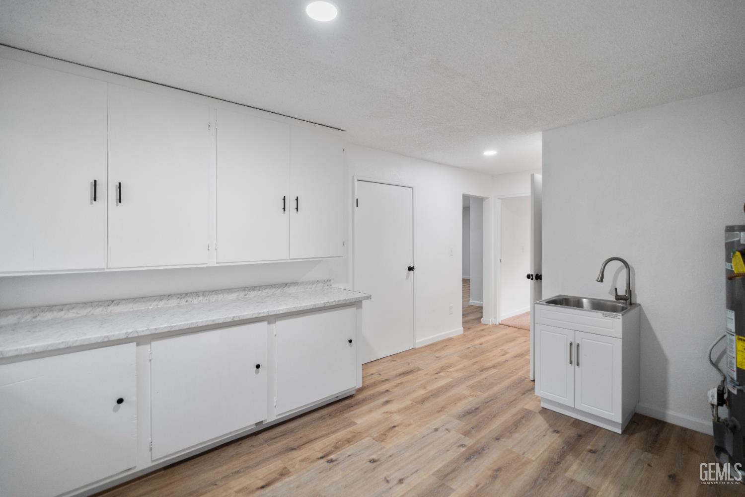 Undisclosed Address Tehachapi, CA 93561 - Photo 45 of 60 a kitchen with a sink cabinets and wooden floor