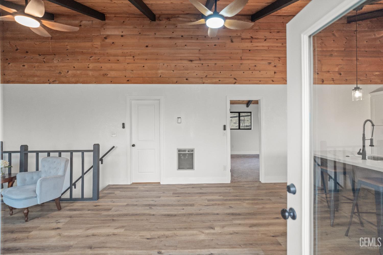Undisclosed Address Tehachapi, CA 93561 - Photo 7 of 60 a view of a hallway with wooden floor and staircase