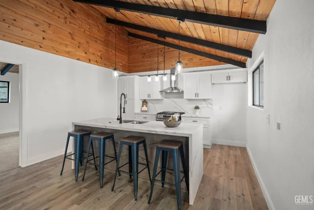 a view of a kitchen with sink and wooden floor