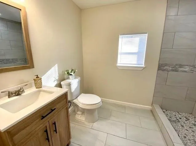 a living room with furniture and a ceiling fan