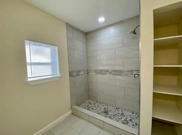 a living room with furniture and a ceiling fan