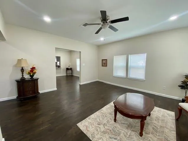 a living room with furniture wooden floor and a window