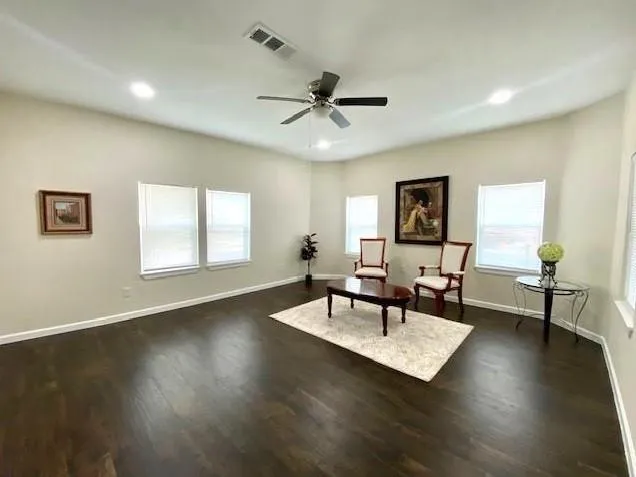 a living room with furniture and wooden floor