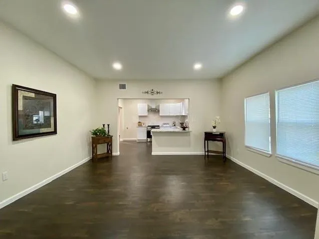 a view of a living room and kitchen with furniture and a refrigerator