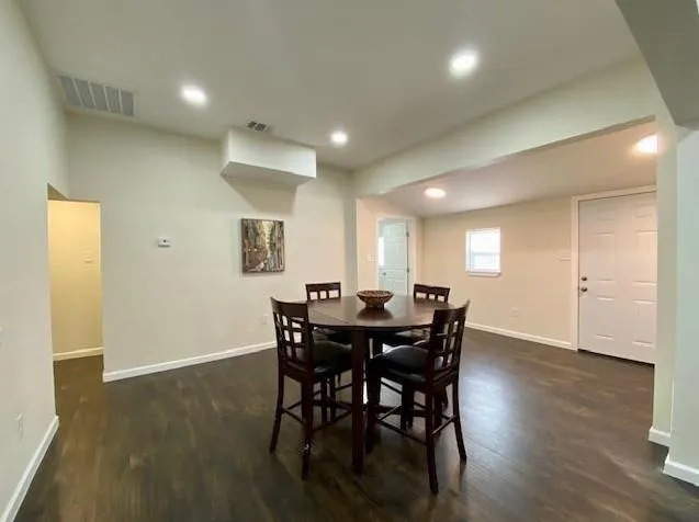 a view of a dining room with furniture and wooden floor