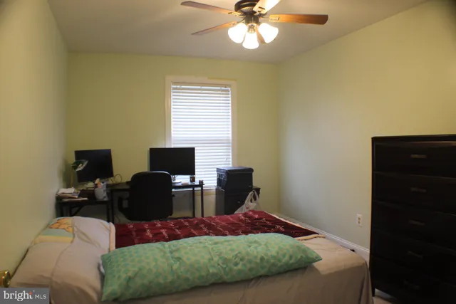 a living room with furniture and a lamp