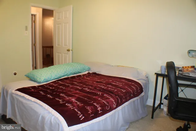 a bed sitting in a bedroom next to a window