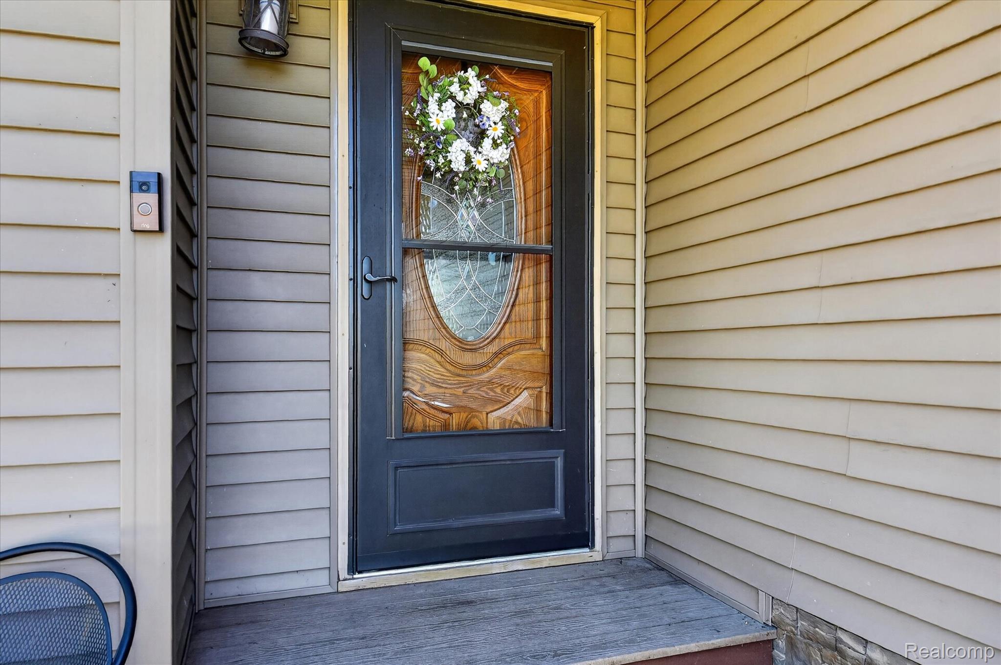 3949 West Burns Line Road Brown City, MI 48416 - Photo 5 of 70 Black storm door with decorative glass inserts and an ornate wood-finish main door