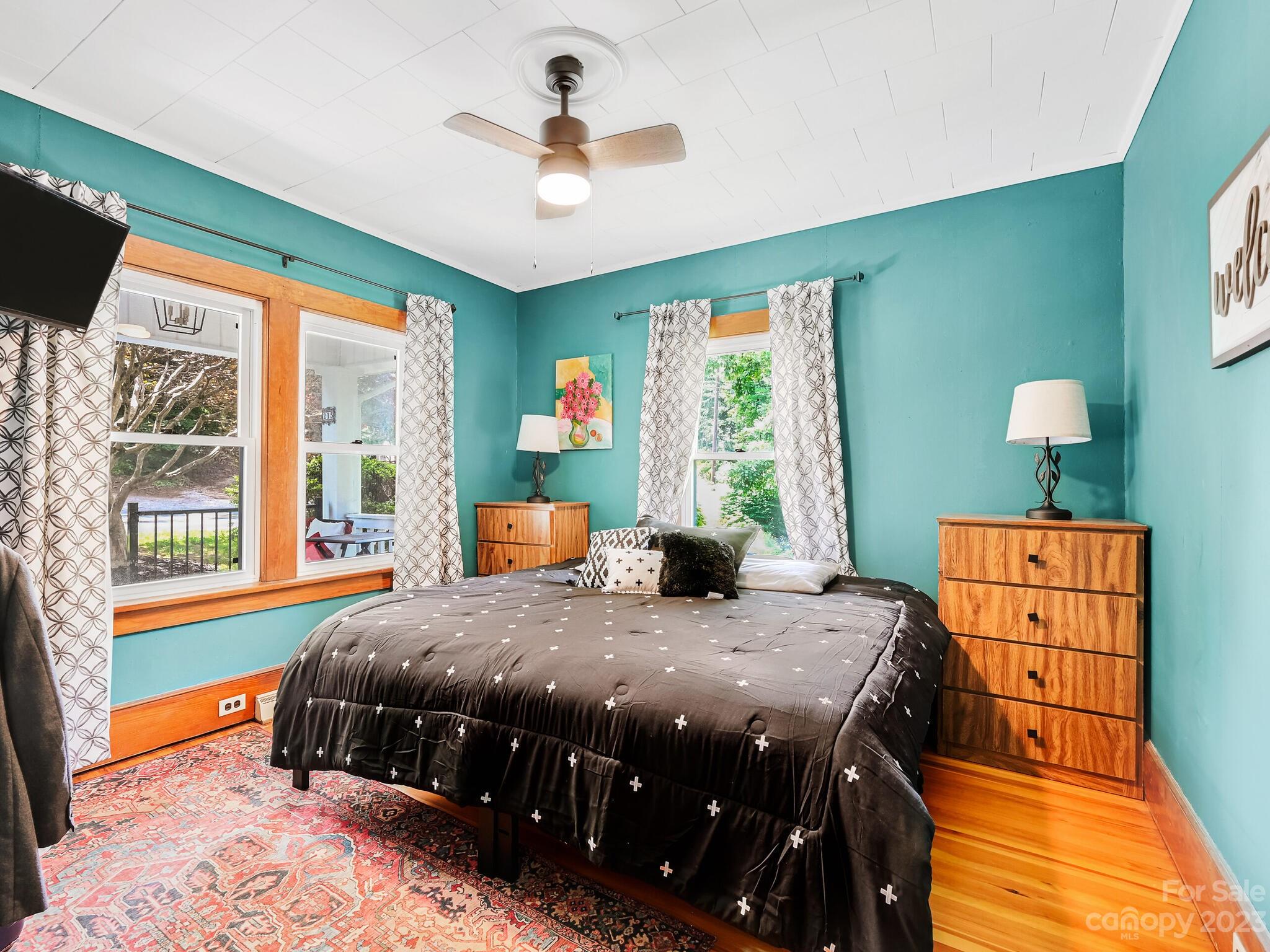 215 Erwin Hills Road Asheville, NC 28806 - Photo 14 of 32 a bedroom with a bed and a table in it