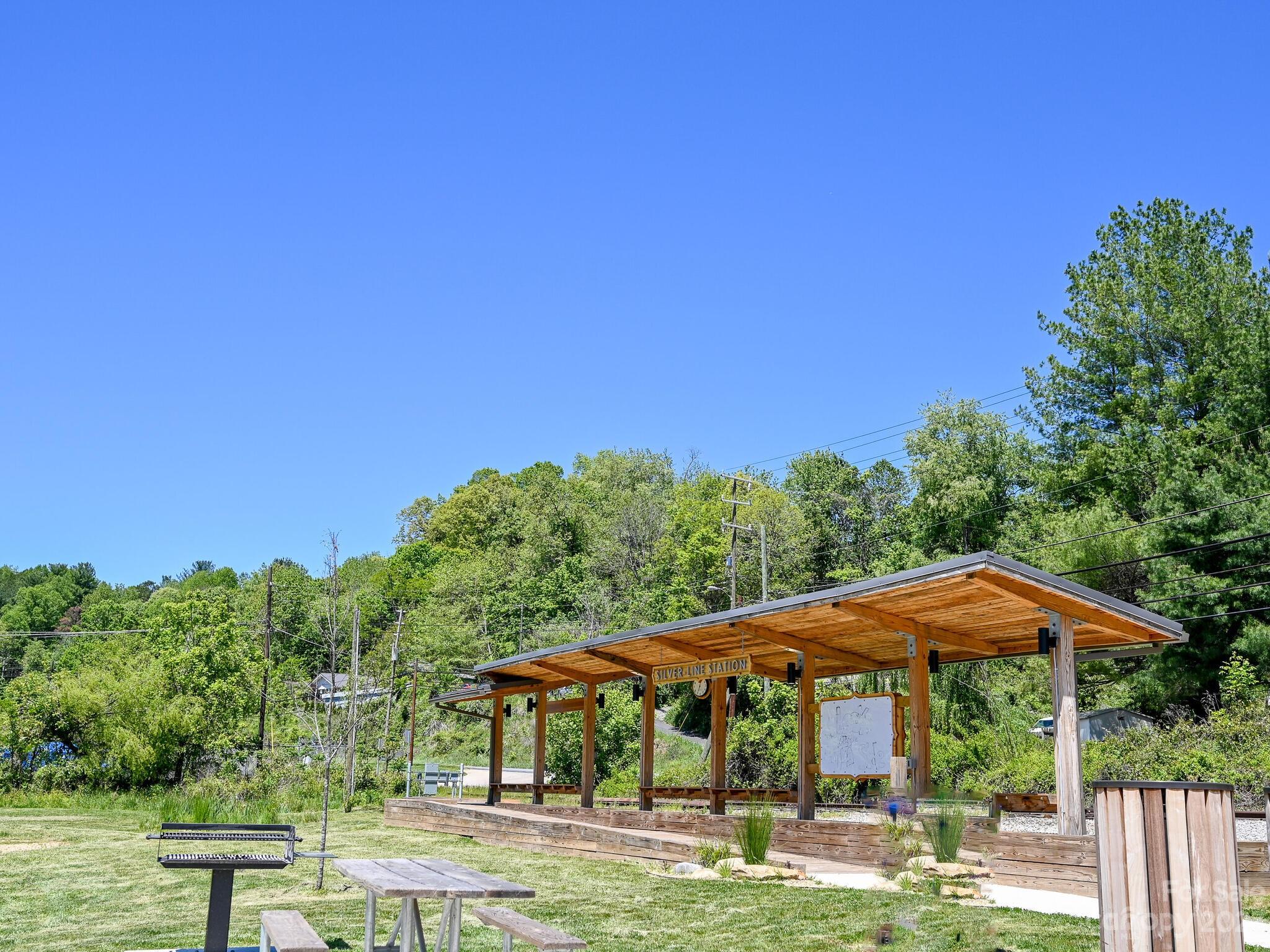 215 Erwin Hills Road Asheville, NC 28806 - Photo 30 of 32 a patio with table and chairs under an umbrella