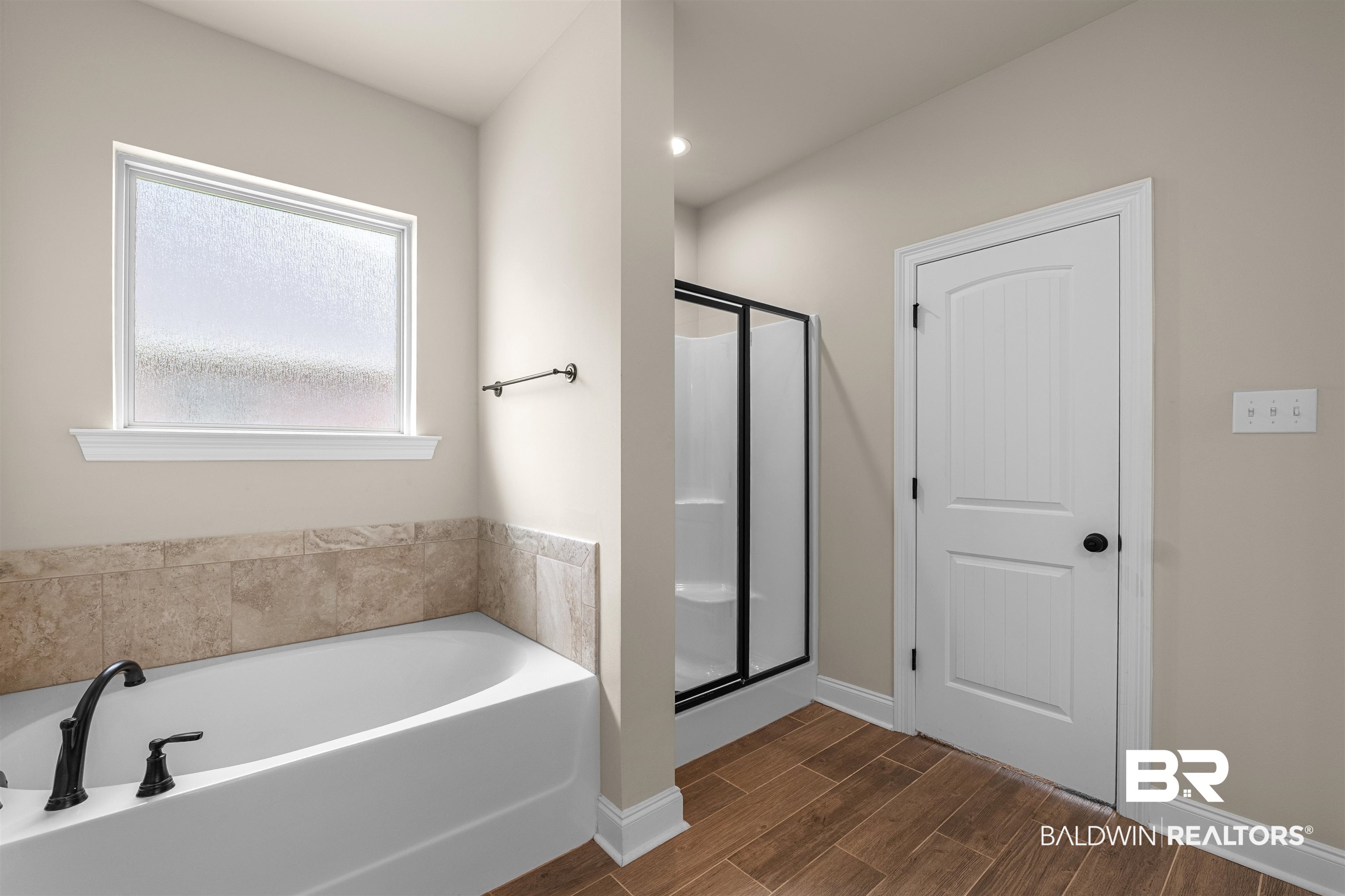 991 Dalton Circle Foley, AL 36535 - Photo 22 of 35 Bathroom featuring a garden tub, a stall shower, and wood finished floors