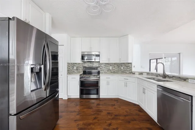 a kitchen with granite countertop stainless steel appliances and wooden cabinets