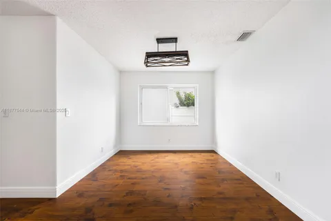 a view of a living room with furniture and wooden floor