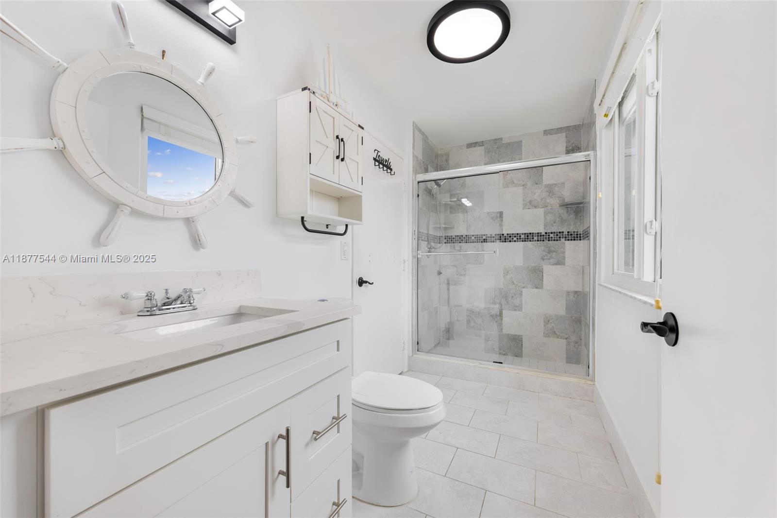 8317 Bermuda Sound Way Boynton Beach, FL 33436 - Photo 22 of 25 a bathroom with a granite countertop sink toilet mirror vanity and shower