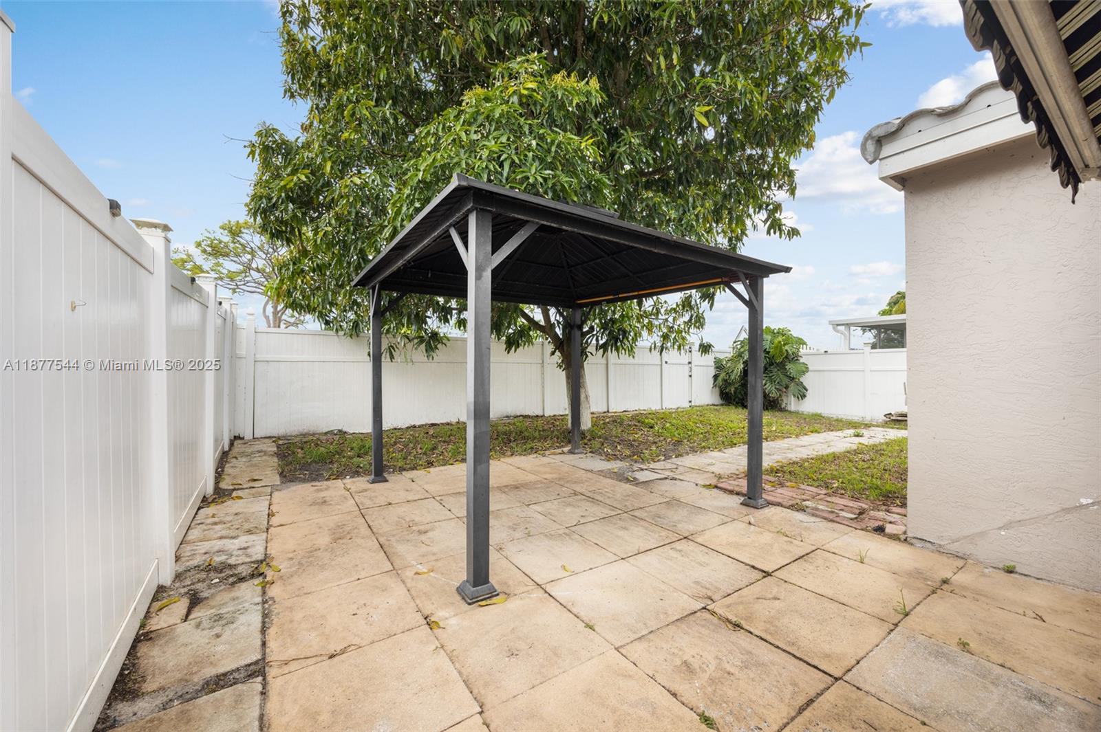 8317 Bermuda Sound Way Boynton Beach, FL 33436 - Photo 24 of 25 a backyard of a house with table and chairs
