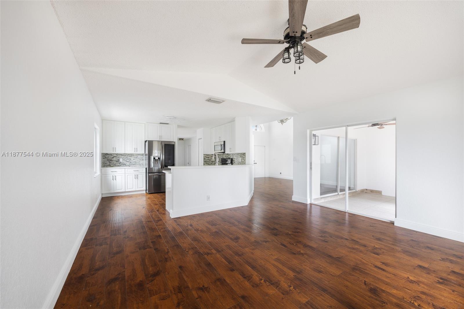 8317 Bermuda Sound Way Boynton Beach, FL 33436 - Photo 10 of 25 a view of a kitchen with wooden floor and a ceiling fan