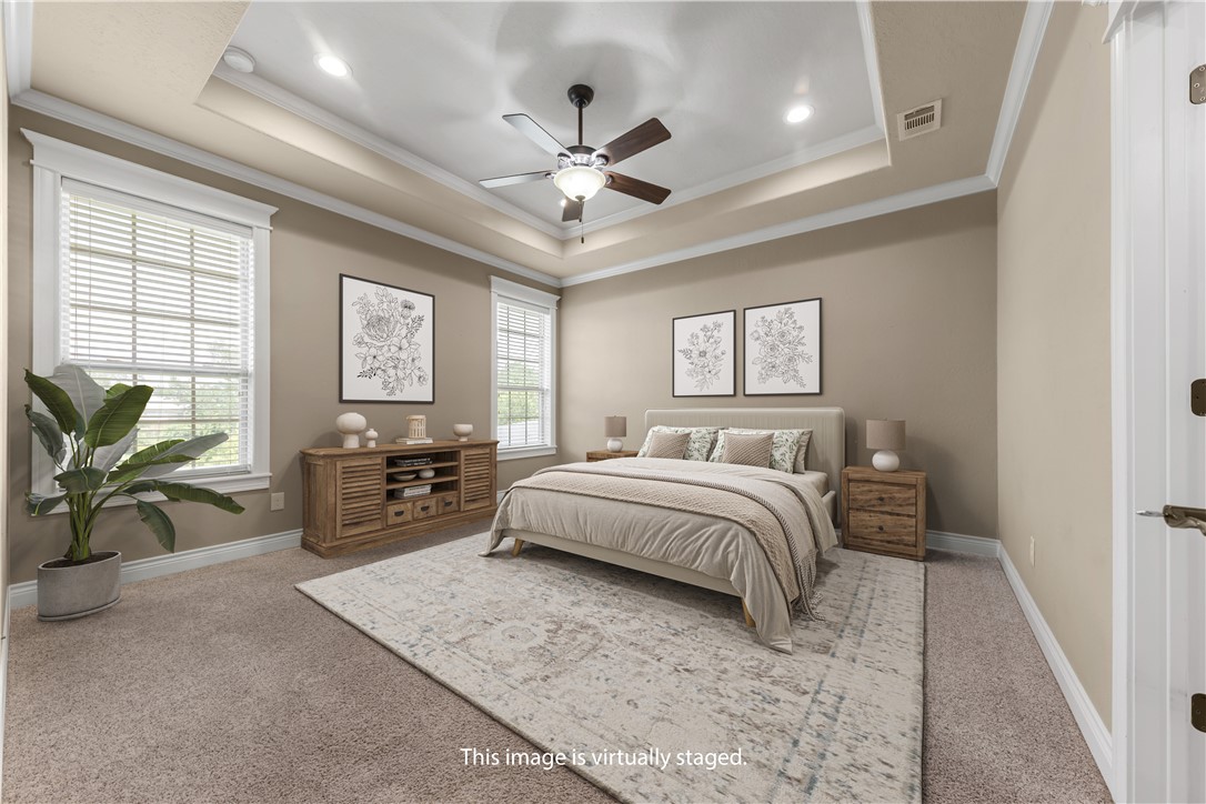 3520 Foxcroft Path Bryan, TX 77808 - Photo 12 of 28 Bedroom with a tray ceiling, light colored carpet, ornamental molding, and a ceiling fan