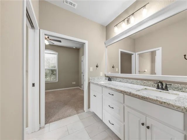 a bathroom with a granite countertop sink mirror and