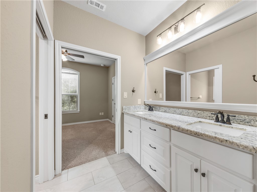 3520 Foxcroft Path Bryan, TX 77808 - Photo 17 of 28 Bathroom with double vanity, light tile patterned flooring, and ceiling fan