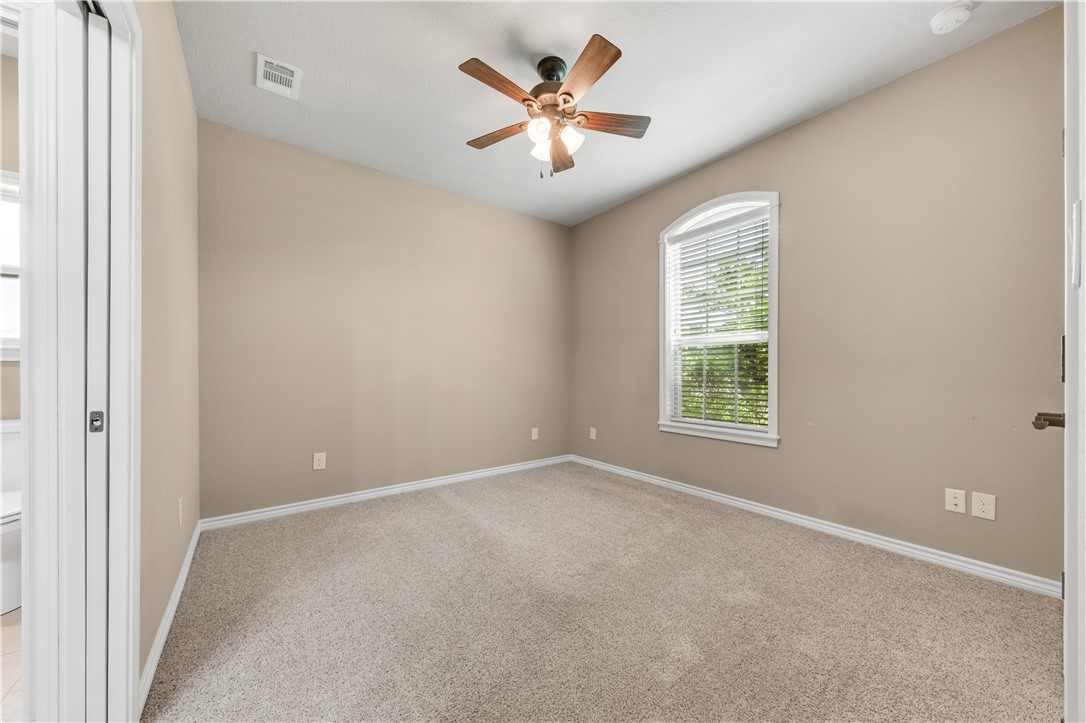 3520 Foxcroft Path Bryan, TX 77808 - Photo 19 of 28 Empty room with light carpet and a ceiling fan