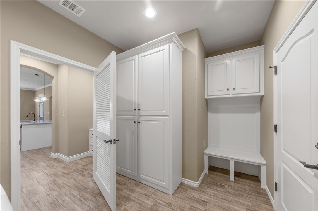 3520 Foxcroft Path Bryan, TX 77808 - Photo 23 of 28 Mudroom with light wood finished floors, arched walkways, and recessed lighting