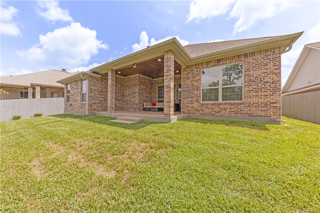 3520 Foxcroft Path Bryan, TX 77808 - Photo 27 of 28 Rear view of house featuring a patio area, brick siding, and roof with shingles
