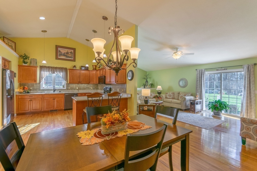 15 Michael Drive, Unit 15 Thorndike, MA 01079 - Photo 11 of 27 a view of a dining room and livingroom with furniture wooden floor a chandelier