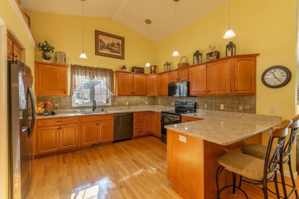 15 Michael Drive, Unit 15 Thorndike, MA 01079 - Photo 15 of 27 a kitchen with a sink cabinets and wooden floor