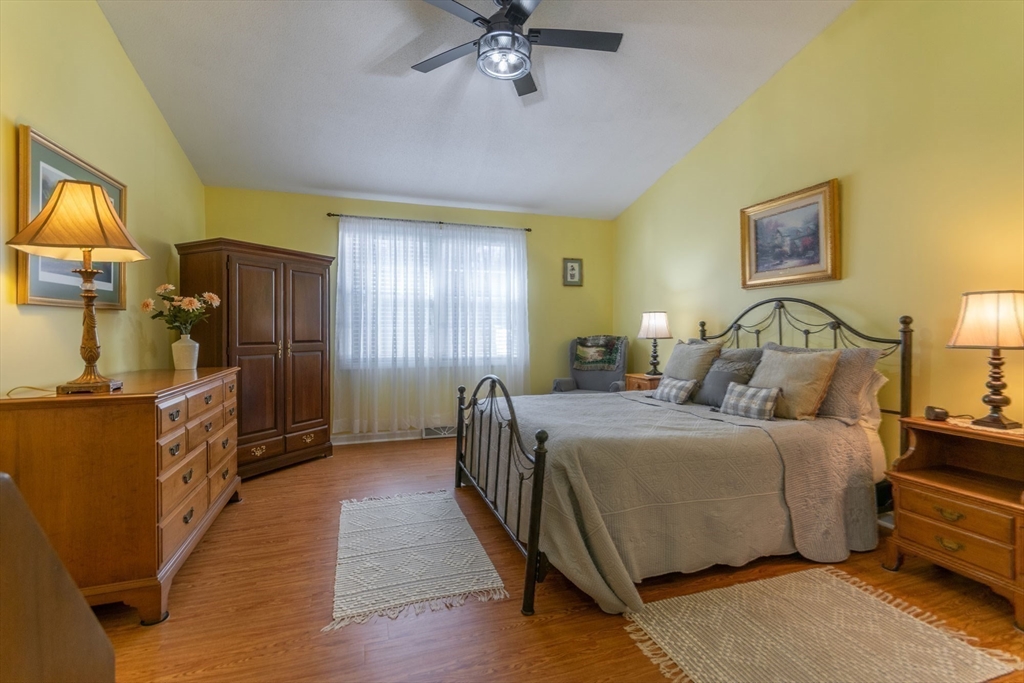 15 Michael Drive, Unit 15 Thorndike, MA 01079 - Photo 16 of 27 a bed room with a bed and a chandelier