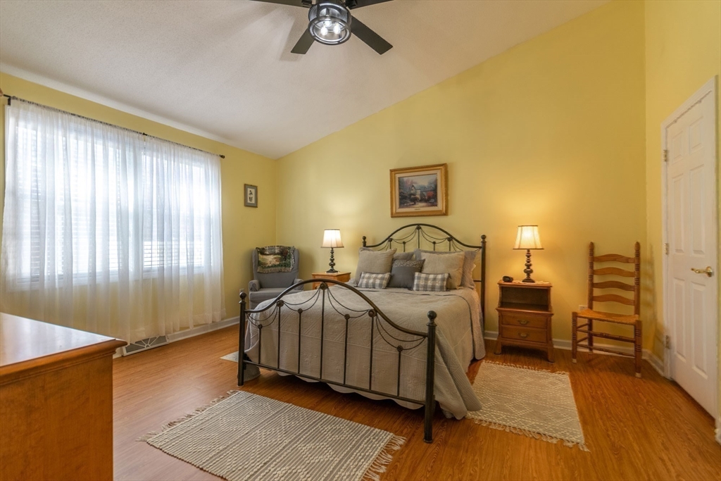 15 Michael Drive, Unit 15 Thorndike, MA 01079 - Photo 17 of 27 a bedroom with a bed and wooden floor