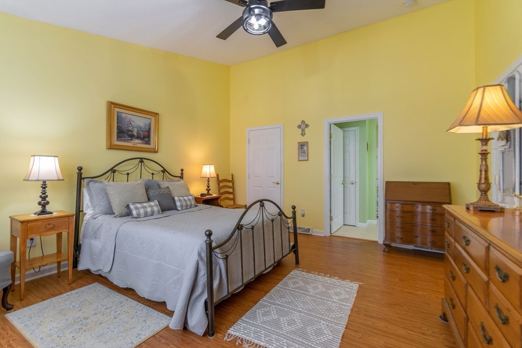 15 Michael Drive, Unit 15 Thorndike, MA 01079 - Photo 18 of 27 a bedroom with a bed and a lamp