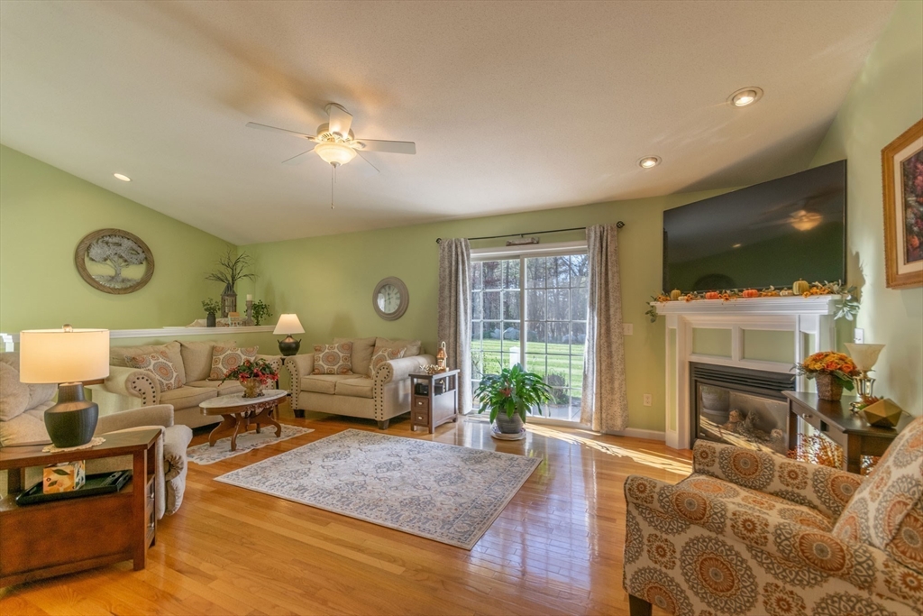 15 Michael Drive, Unit 15 Thorndike, MA 01079 - Photo 2 of 27 a living room with furniture a flat screen tv and a fireplace