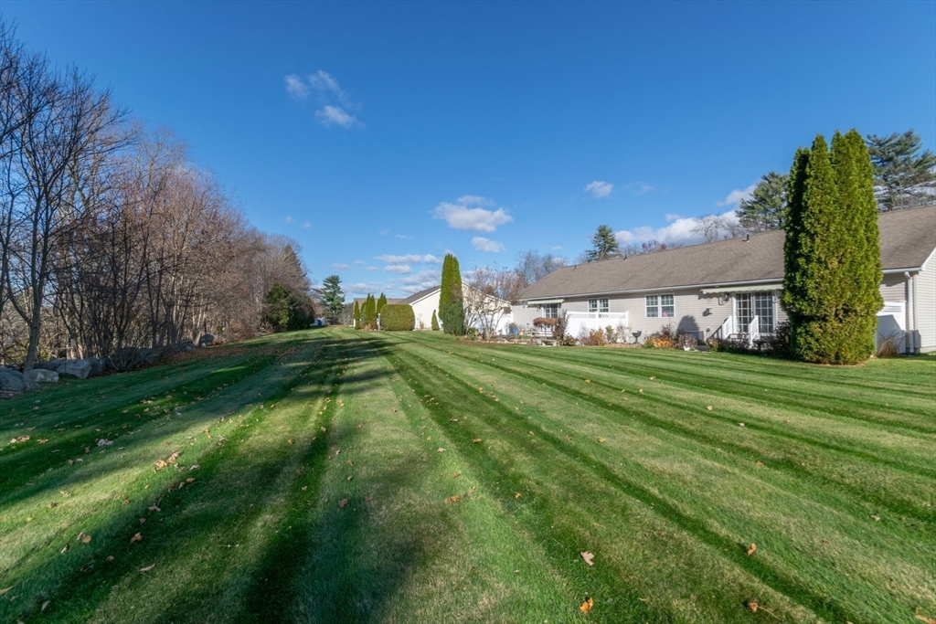 15 Michael Drive, Unit 15 Thorndike, MA 01079 - Photo 25 of 27 a view of yard with swimming pool and green space